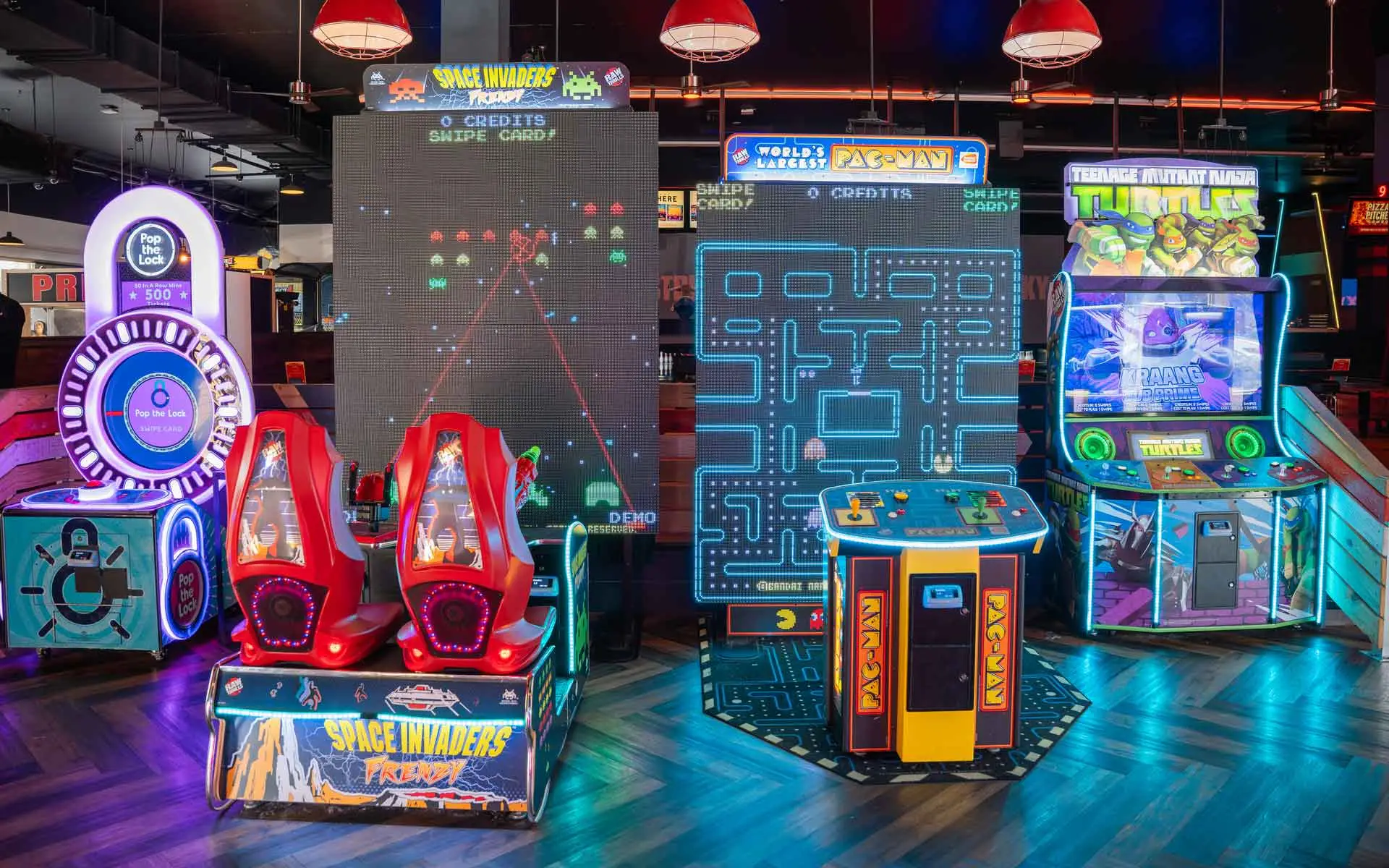 Large and colorful arcade games in a beautiful arcade room.