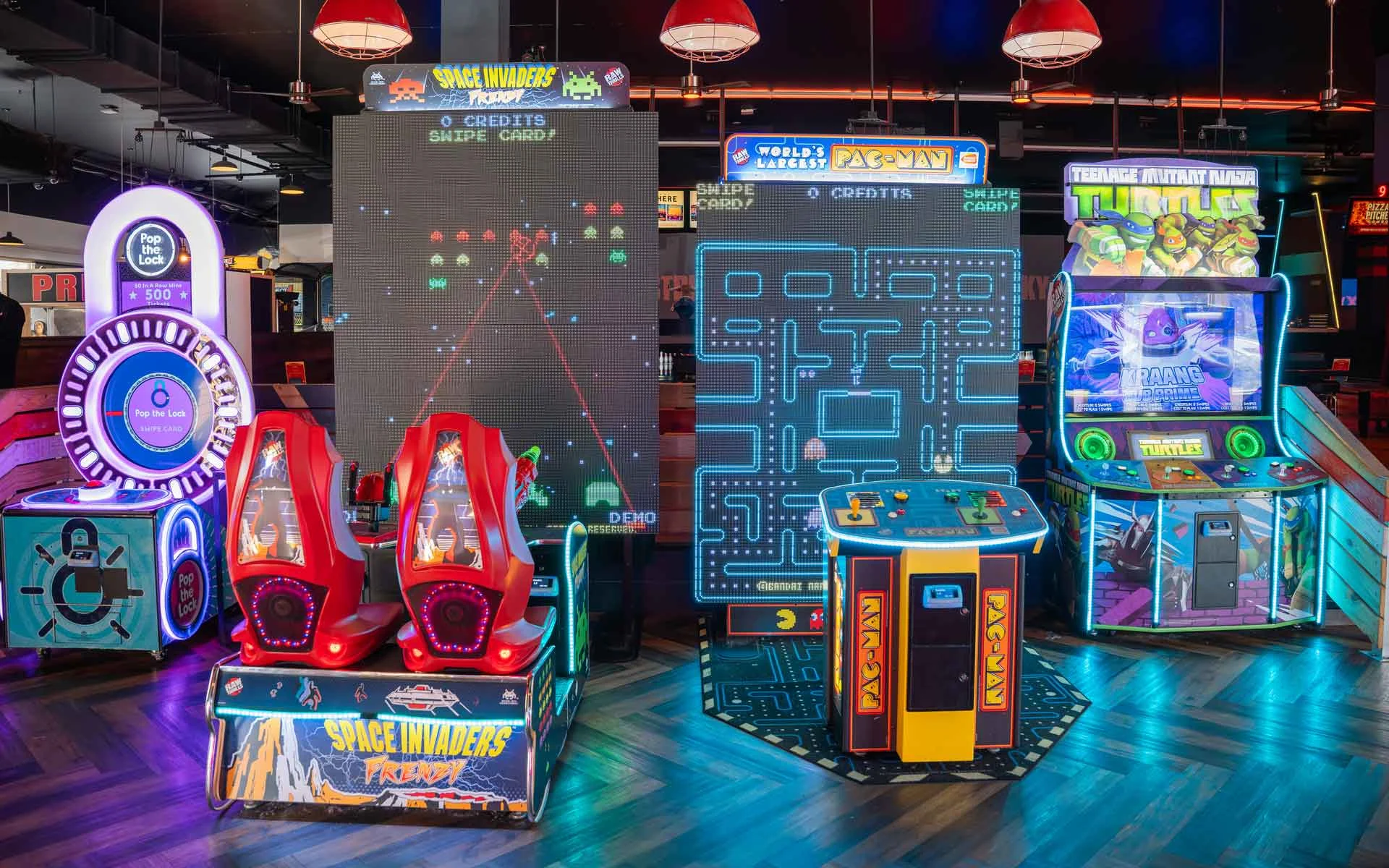 Large and colorful arcade games in a beautiful arcade room.