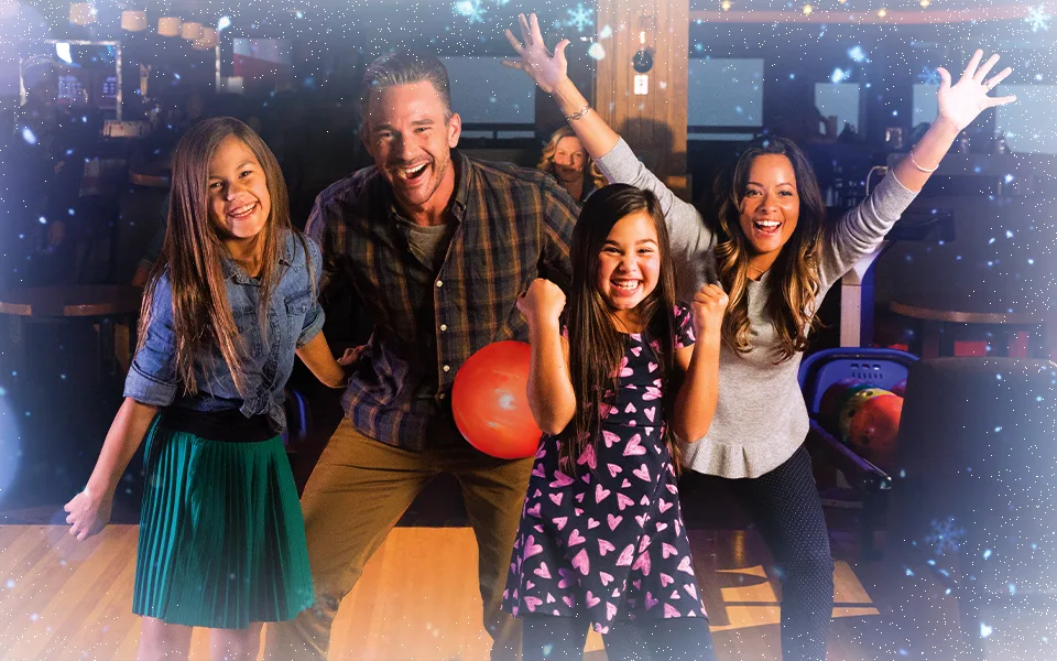 Four bowlers celebrating on the lanes with a winter festive theme overlay on the image.