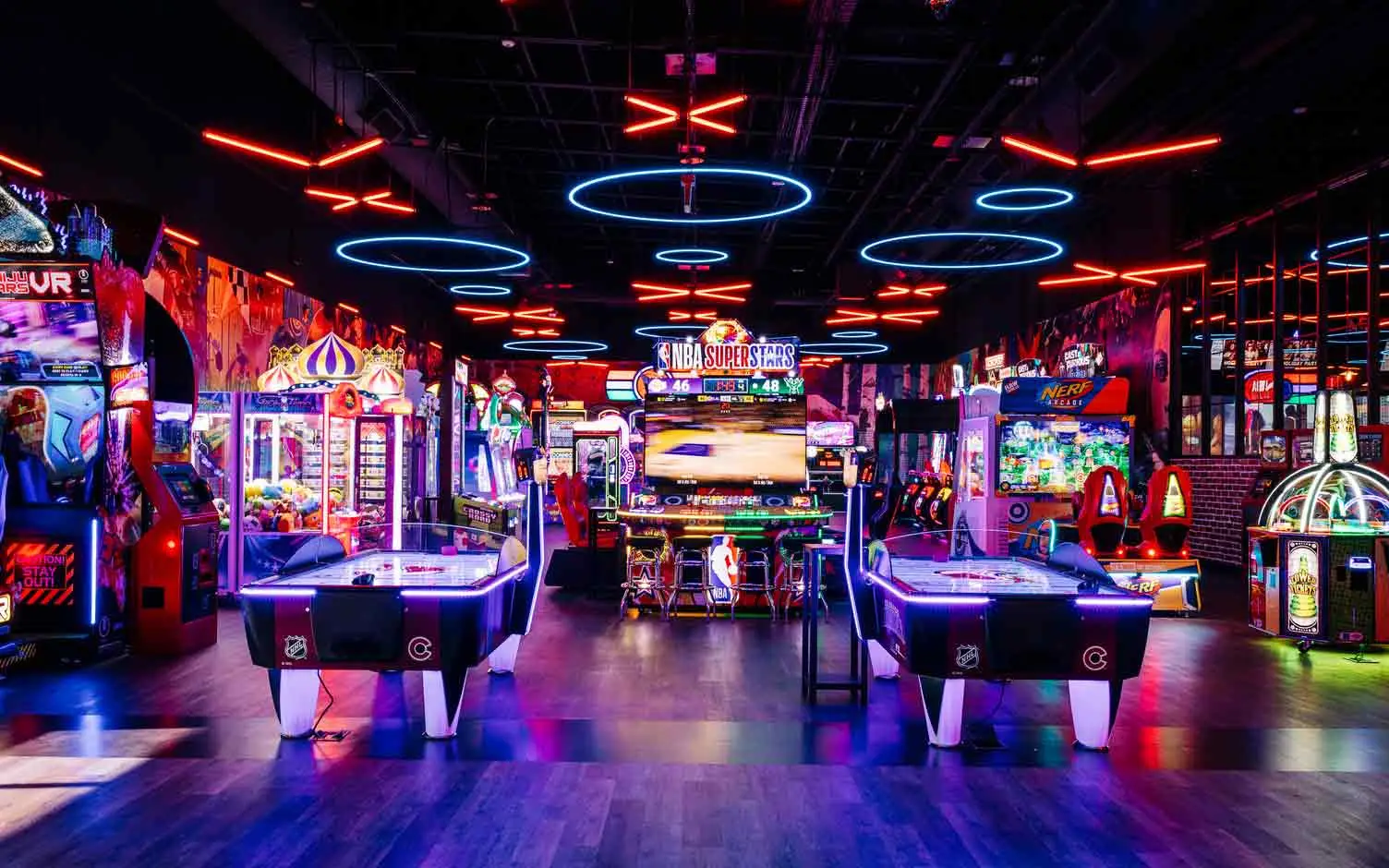 Wide view of arcade games including NBA Superstars, VR, and claw machines at Lucky Strike Southlands