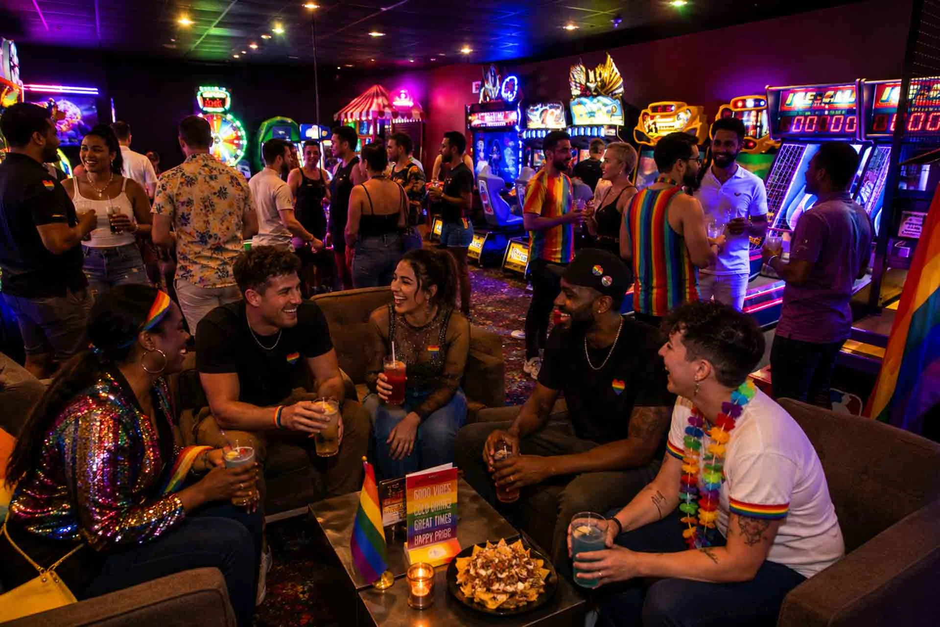 Friends celebrating Atlanta Pride Month at Lucky Strike Atlantic Station, enjoying arcade games, cocktails, and nightlife in a vibrant Midtown Atlanta entertainment venue.