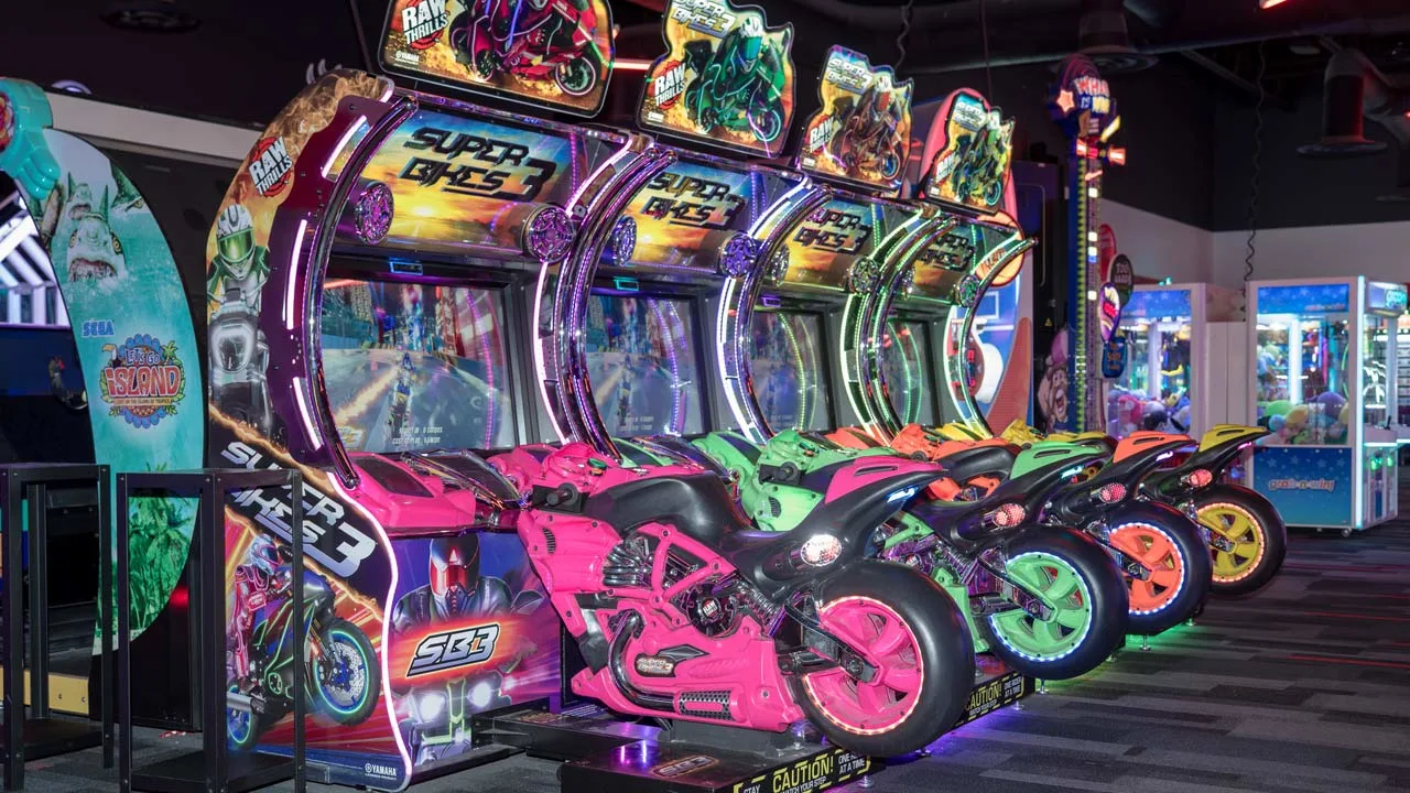 Large and colorful arcade games in a beautiful arcade room.