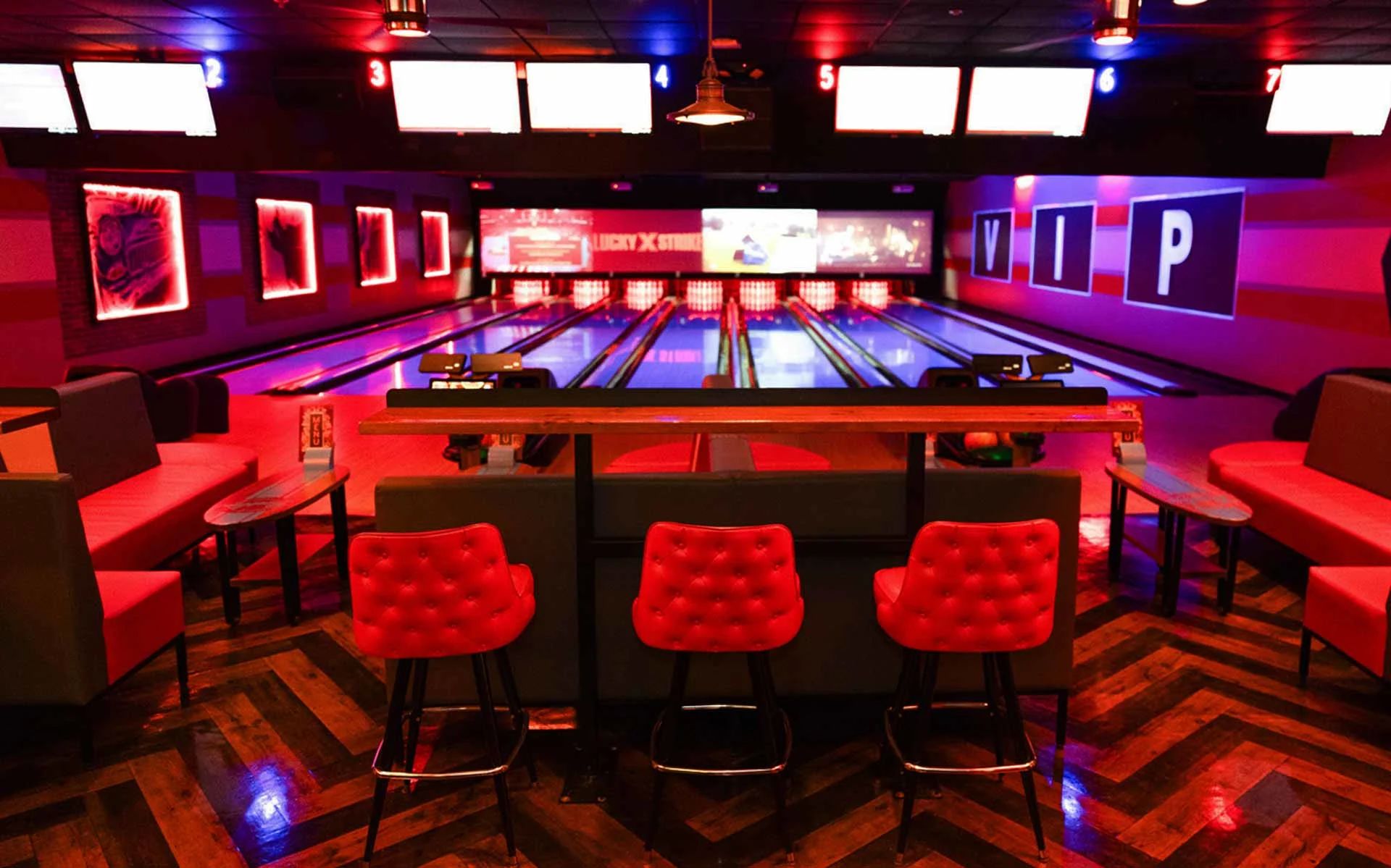 VIP bowling lanes at Lucky Strike with lounge seating, red accent lighting, and private upscale bowling experience.