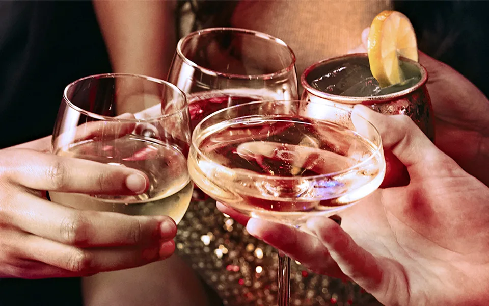 Four drinks being toasted together