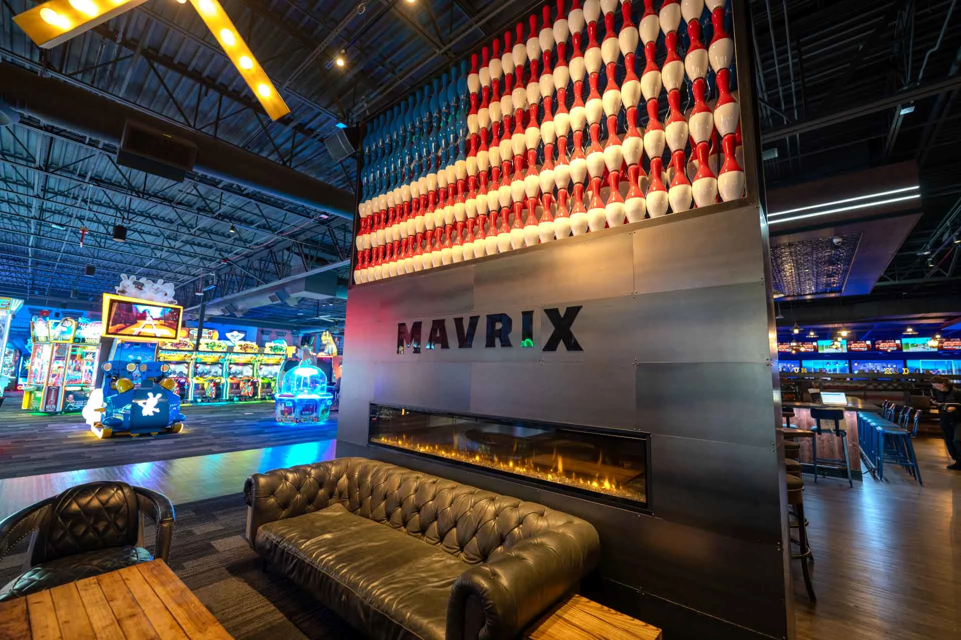 Mavrix Entertainment Center lobby lounge featuring a decorative wall of bowling pins and seating area.