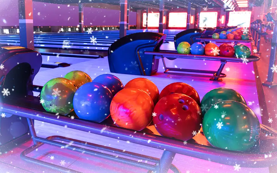 Return rack loaded with colorful bowling balls and holiday festive theme