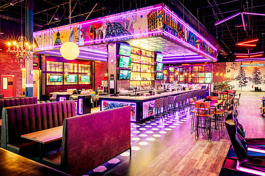 Beautiful lounge in the foreground with colorful, large bar in the background