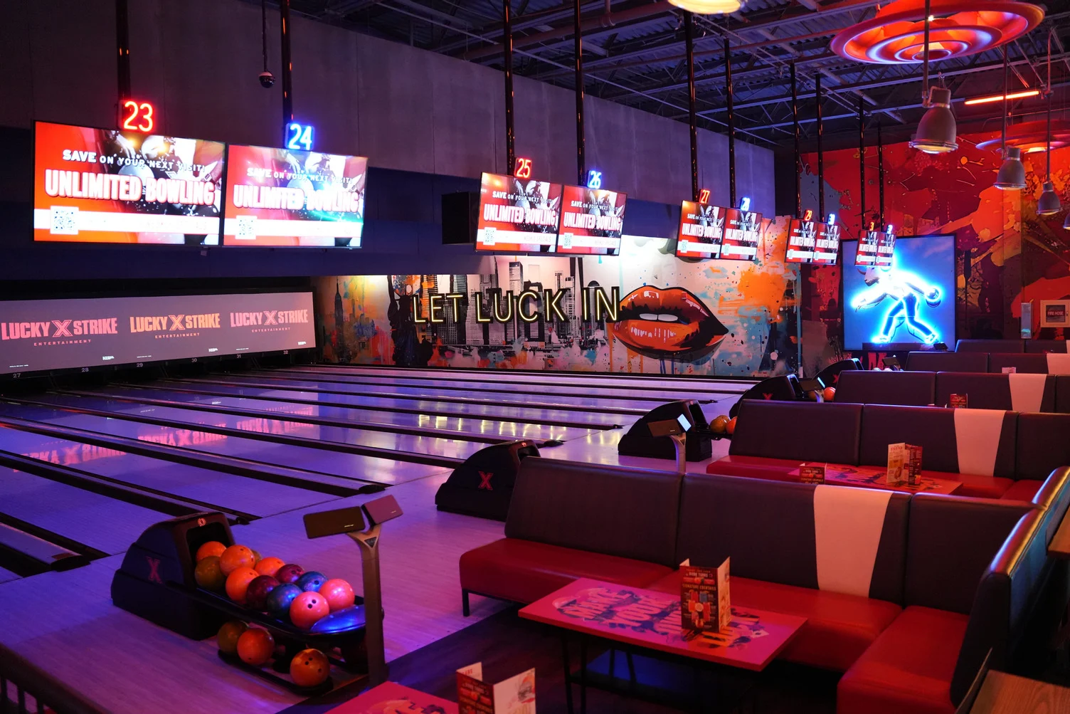 Beautiful bowling lanes with large TV screens above the lanes and spacious, comfortable seating.