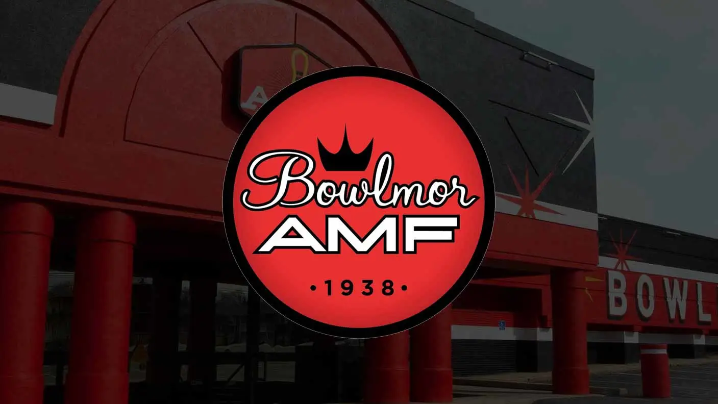 Bowlmor AMF logo centered over the exterior of an AMF bowling alley with red columns and retro-style architectural details.