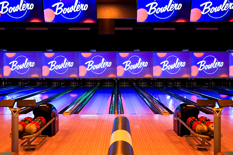 Bowling lanes with large TVs above them