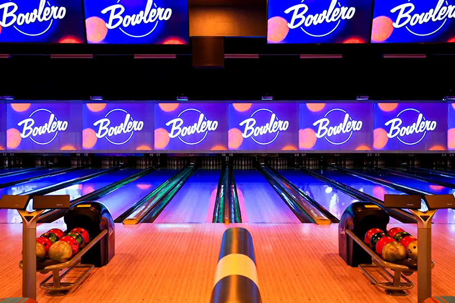 Bowling lanes with large TVs above them