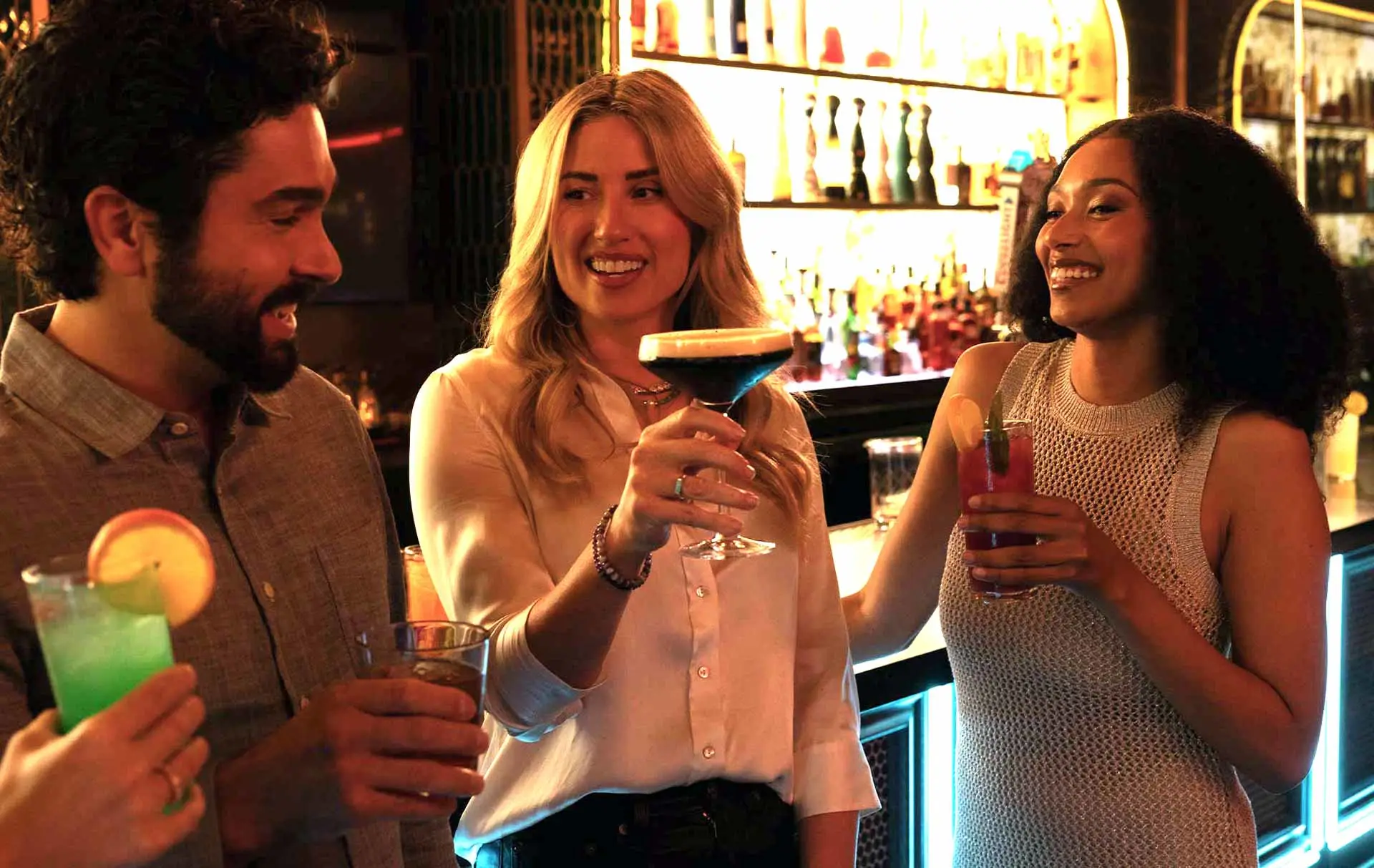 Friends enjoying cocktails at the Lucky Strike bar, smiling and celebrating in a stylish nightlife setting.