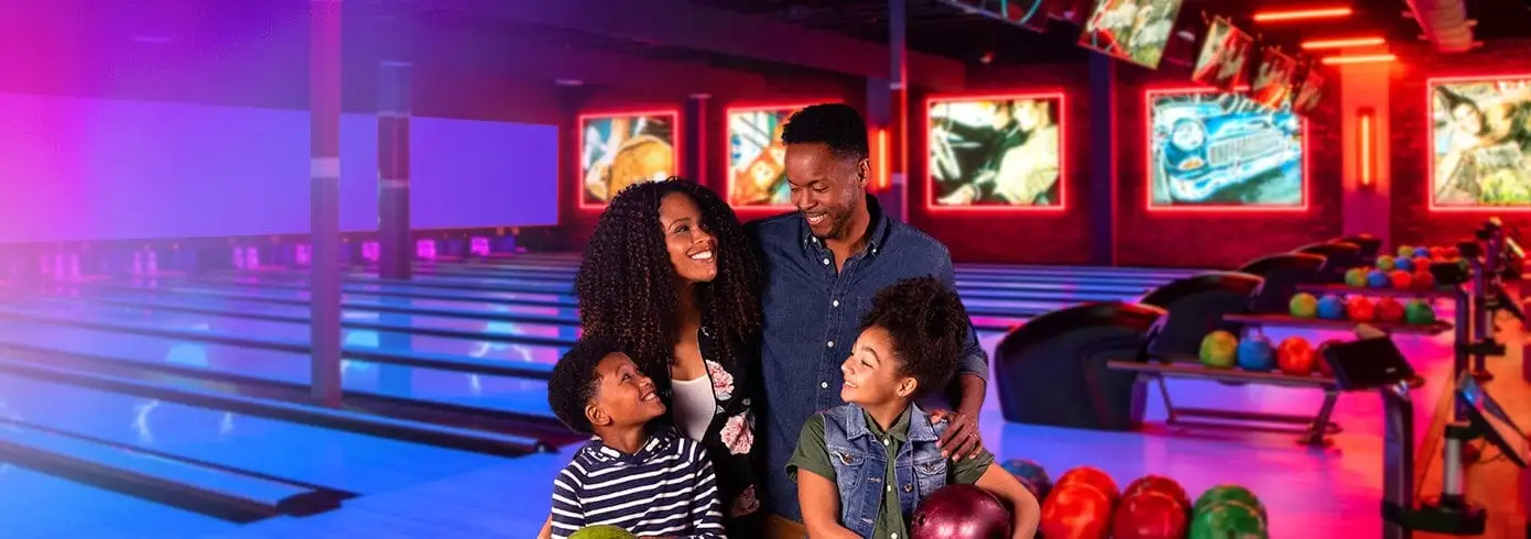 Family of four enjoying bowling together