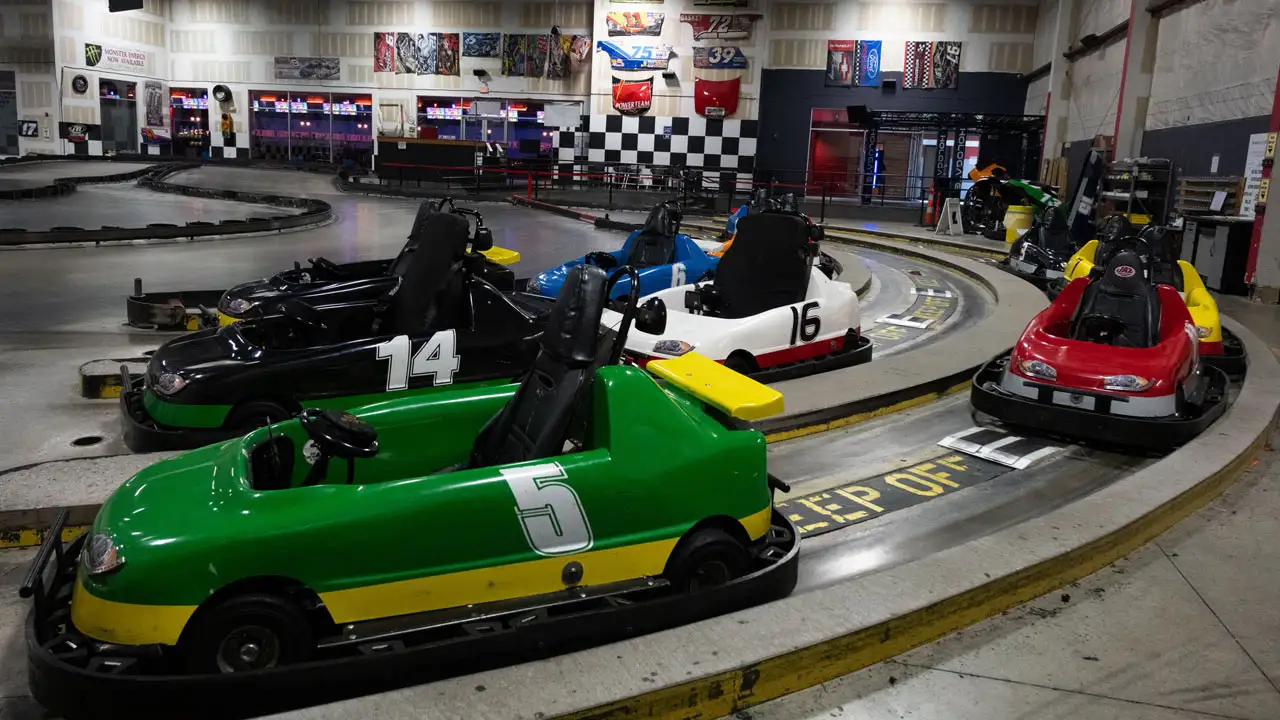 Several go karts lined up on a track and ready to drive