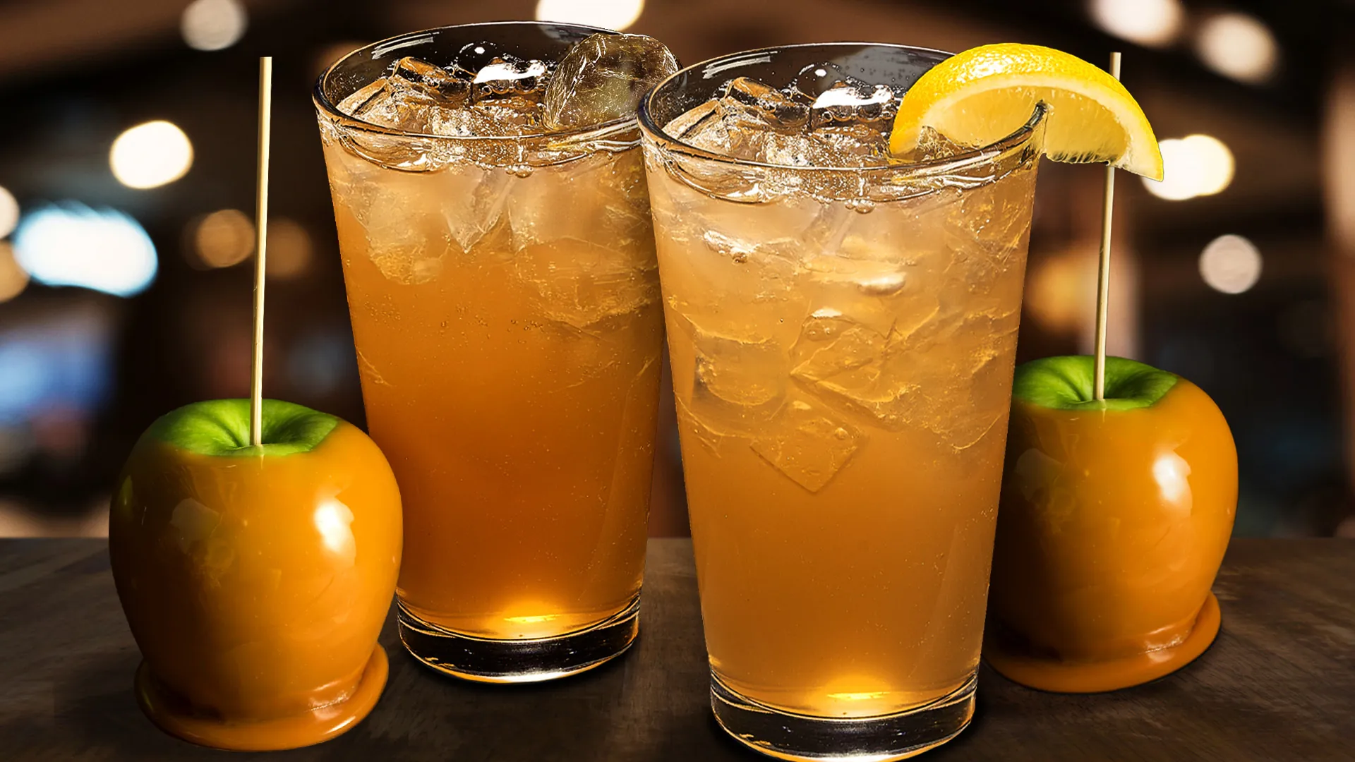 Two Apple Caramel lemonades with caramel-covered apples next to each of them