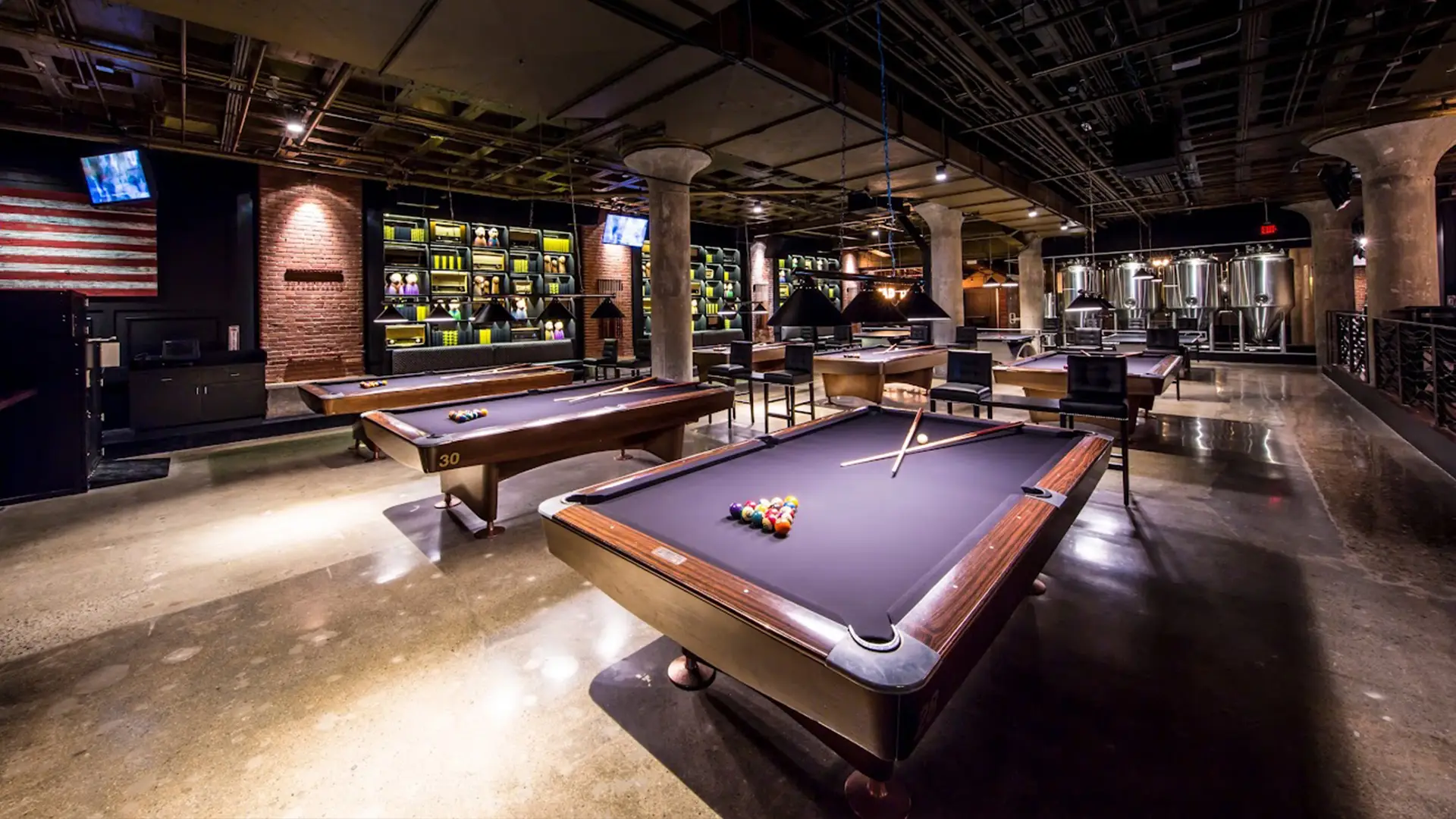 Cheeky Monkey entertainment space featuring billiards tables, lounge seating, and vintage décor.