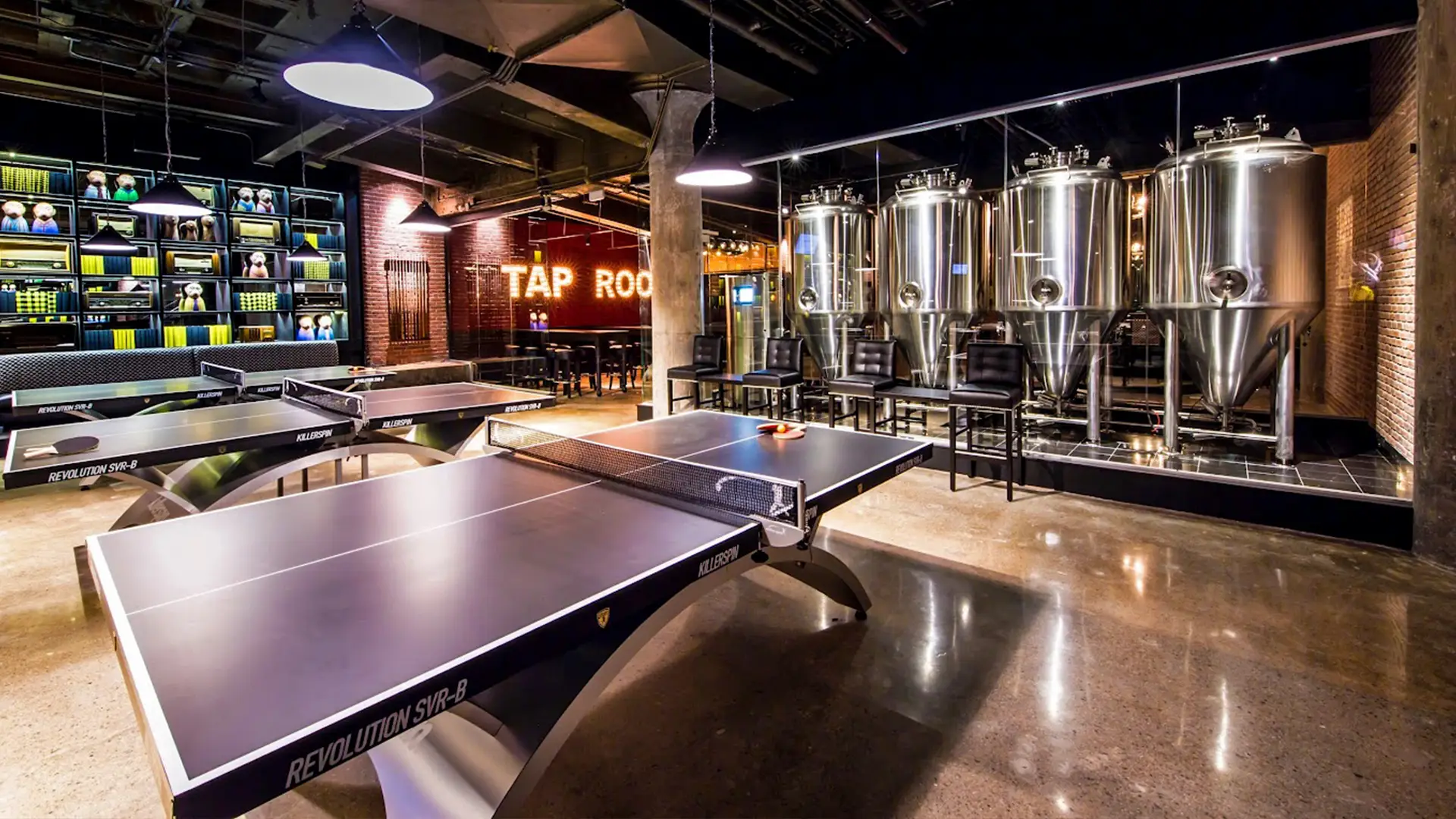 Cheeky Monkey tap room with ping pong tables, large brewing tanks, and modern industrial design.