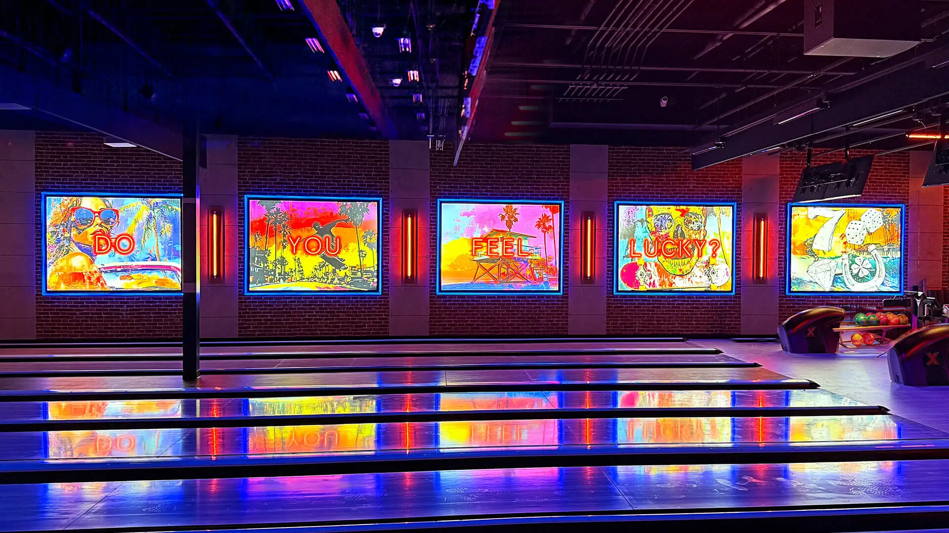 Colorful neon artwork displaying the phrase “Do You Feel Lucky?” above bowling lanes at Lucky Strike, featuring vibrant lighting and a modern bowling alley atmosphere.