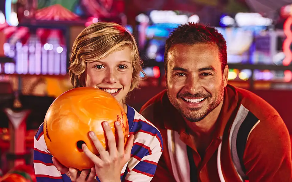 Father and son at bowling center