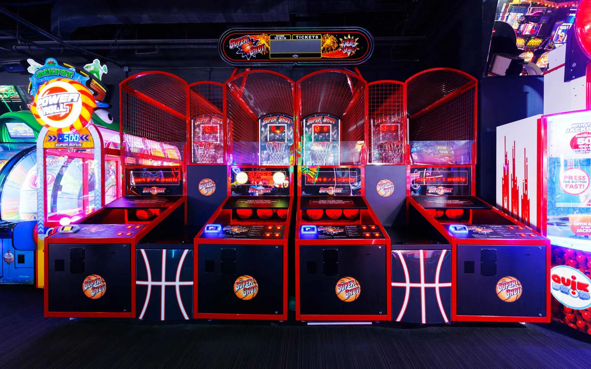 Interactive game zone featuring basketball hoops and ticket-based machines. A lively, competitive space that adds variety and keeps groups engaged between rounds.