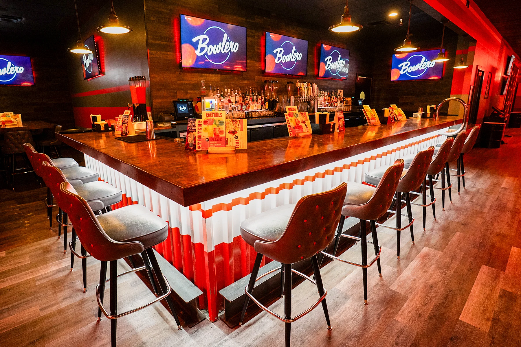 Classic bar, beautifully lit with lots of stools and big TVs