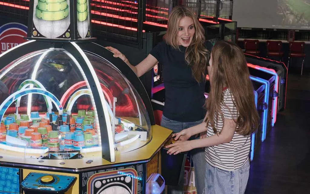 Mother and daughter enjoying arcade games together at AMF