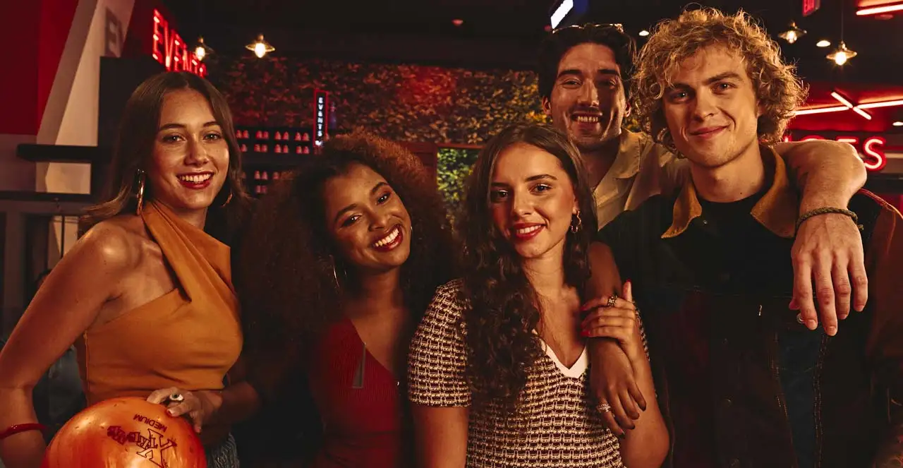 A group of friends at lane scoring at a Lucky Strike center.