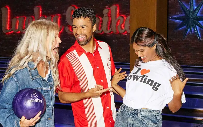 Friends laughing together on the Lucky Strike bowling lanes