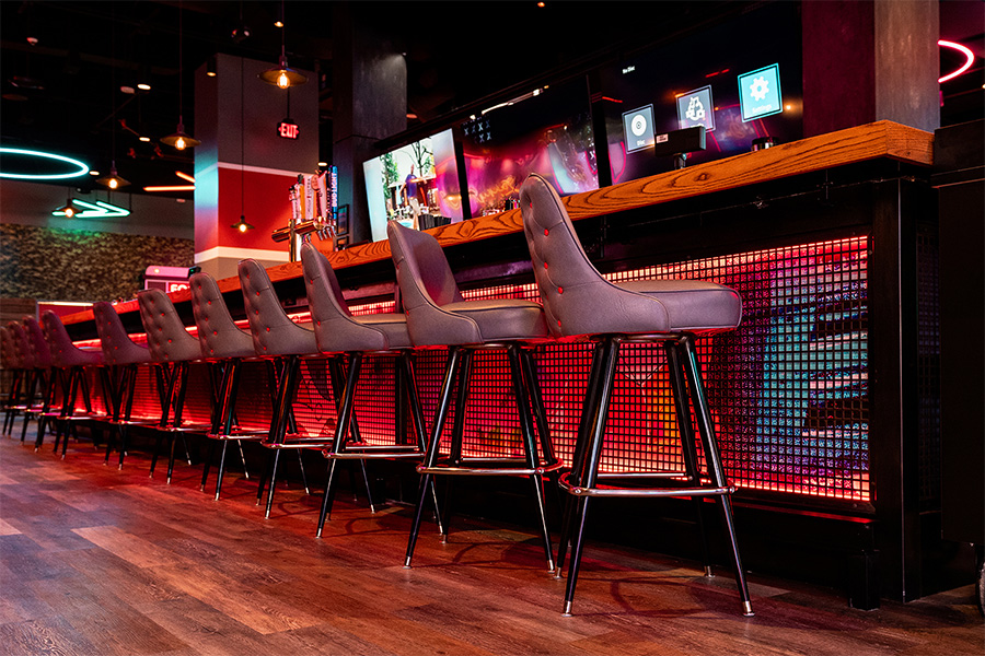 Large, shiny bar with lots of seating
