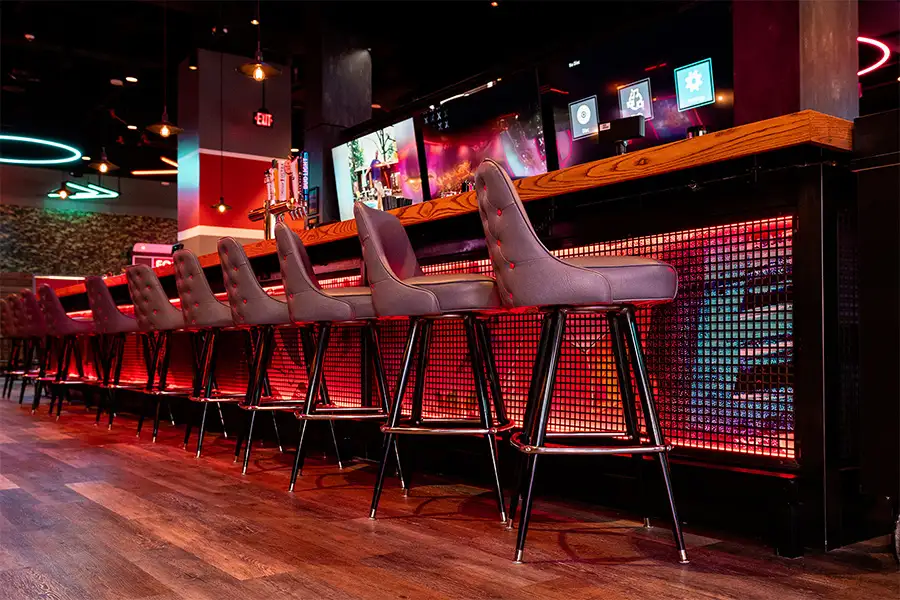 Large, shiny bar with lots of seating
