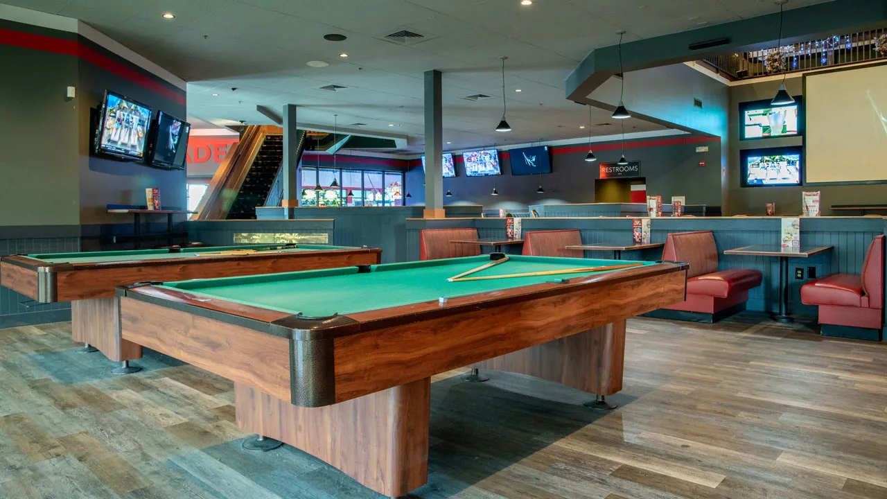 Nice billiards tables with a large bowling center in the background