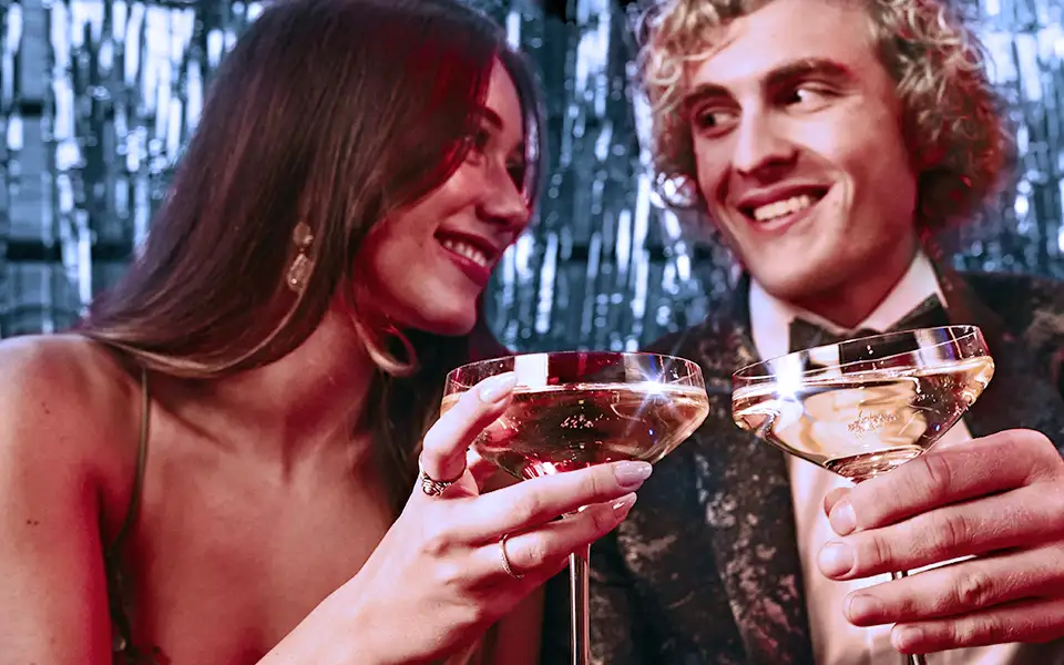 Formally dressed man and woman toasting champagne