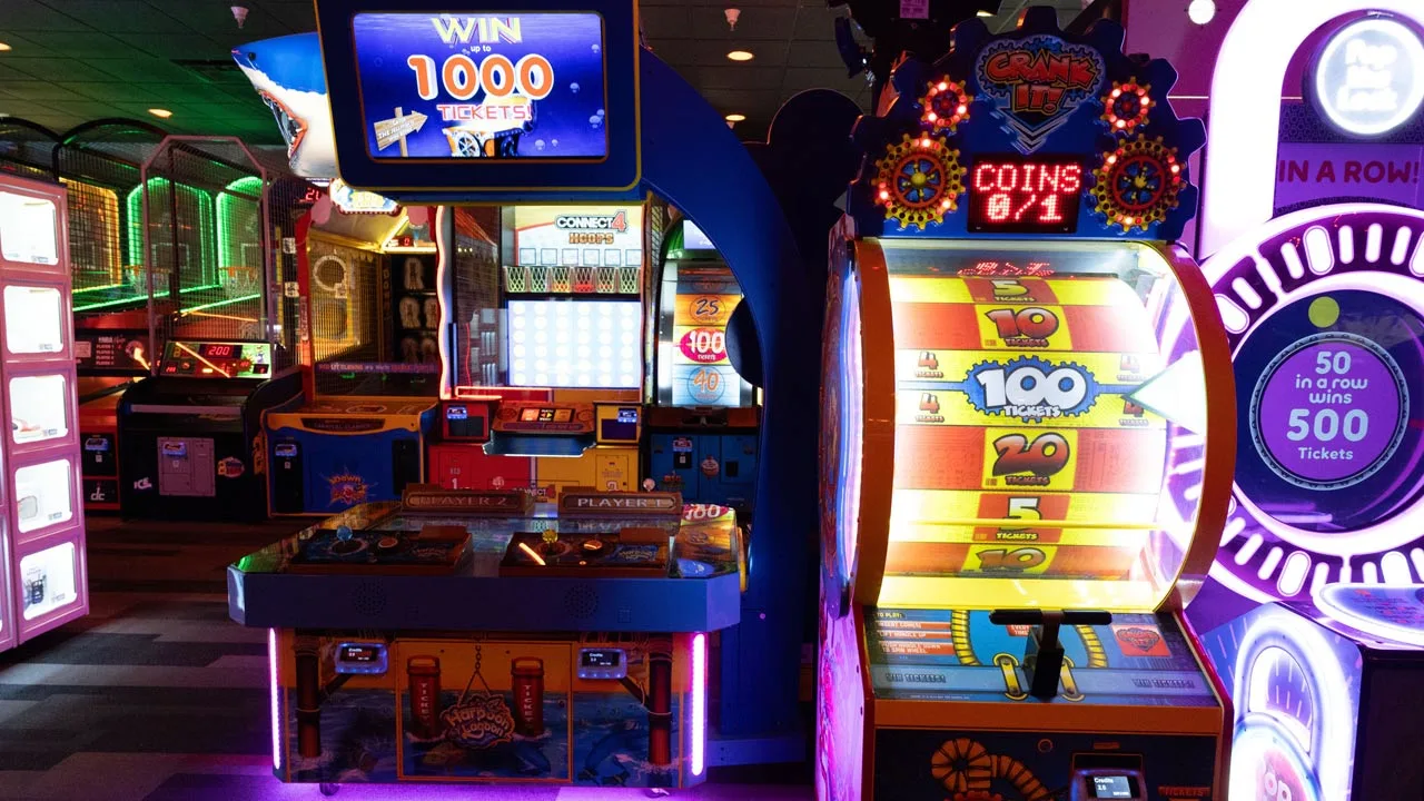 Large and colorful arcade games in a beautiful arcade room.