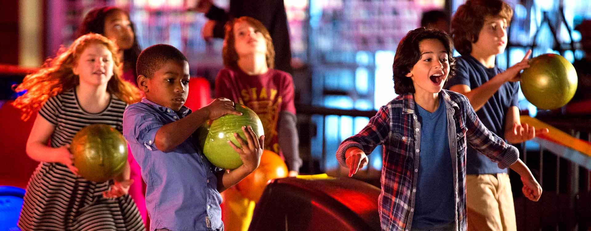 Kids having fun and bowling at an AMC bowling alley