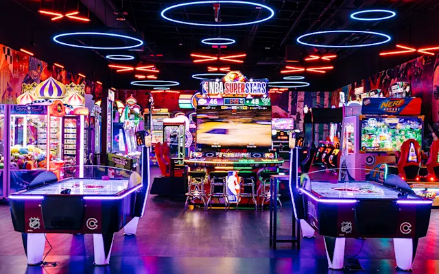 View of various arcade games and air hockey tables.