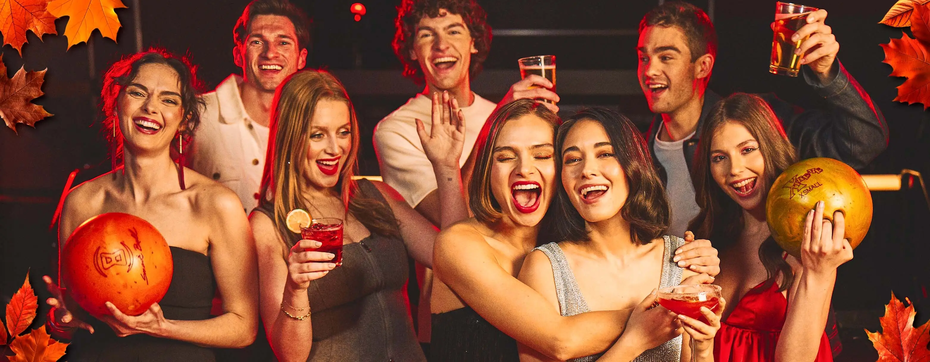 Large group of friends having fun with drinks with an autumn-themed background. 