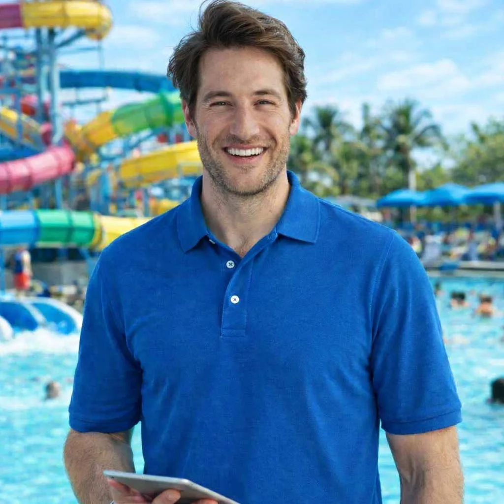 Professional smiling in a business environment holding a tablet, representing sales and business development careers.