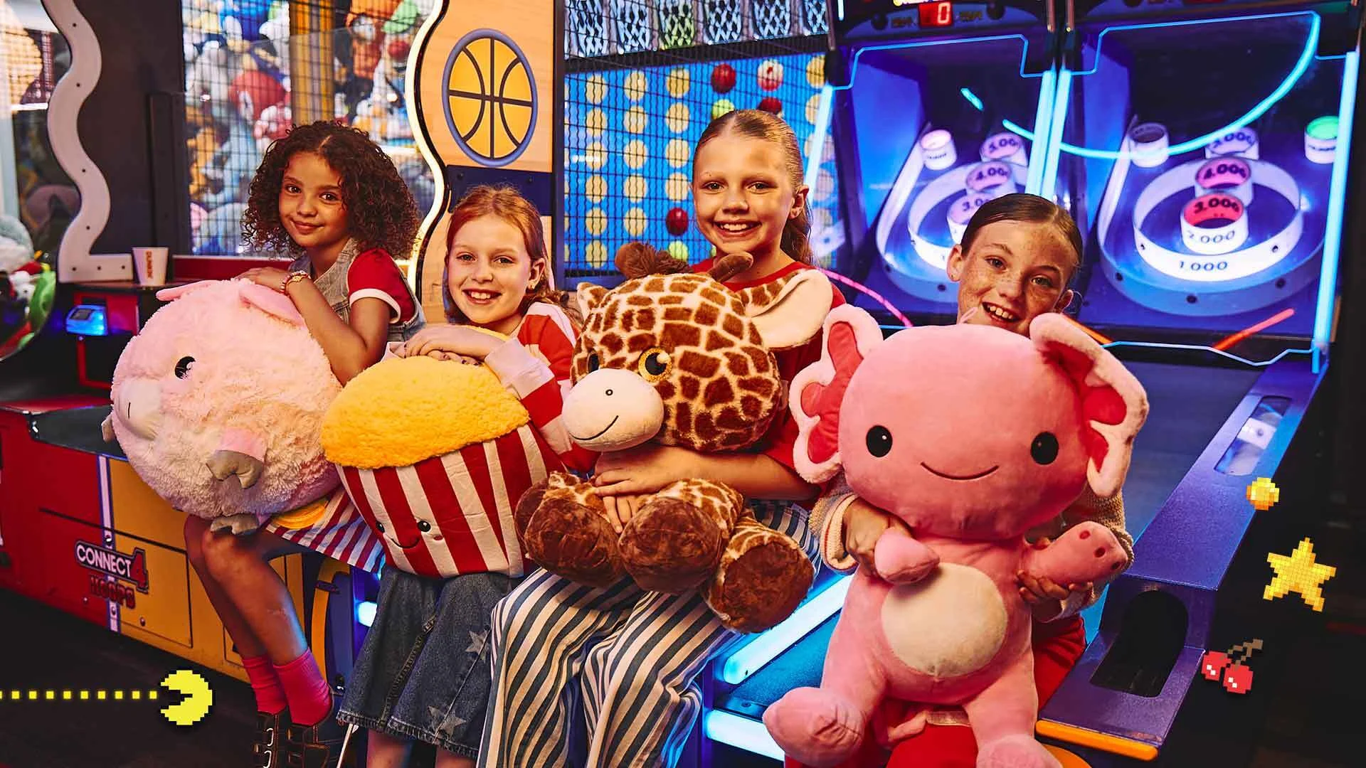 Four kids with stuffed animals and an arcade in the background.