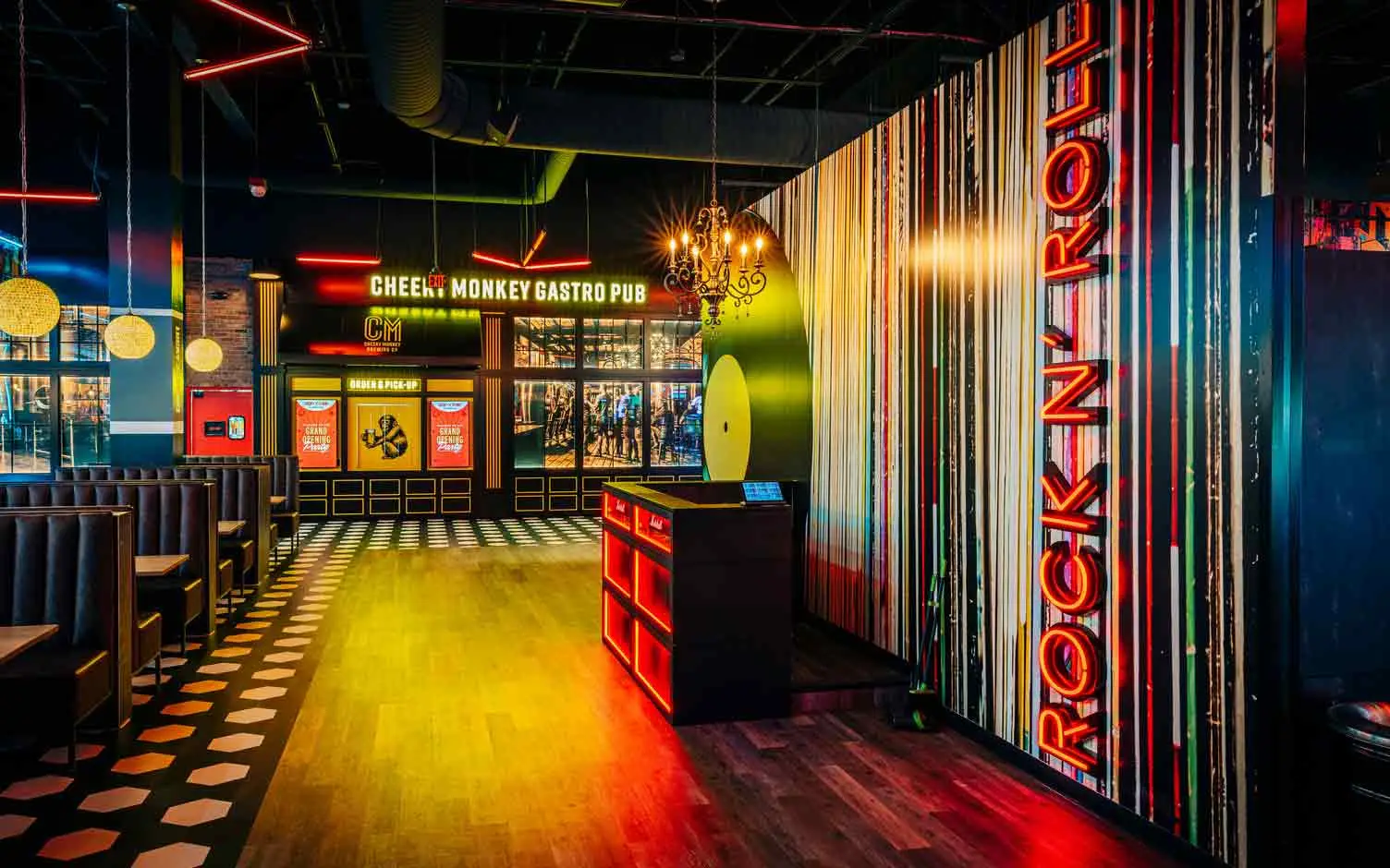Cheeky Monkey Gastro Pub entrance with Rock N Roll neon sign and vinyl wall mural at Lucky Strike Southlands