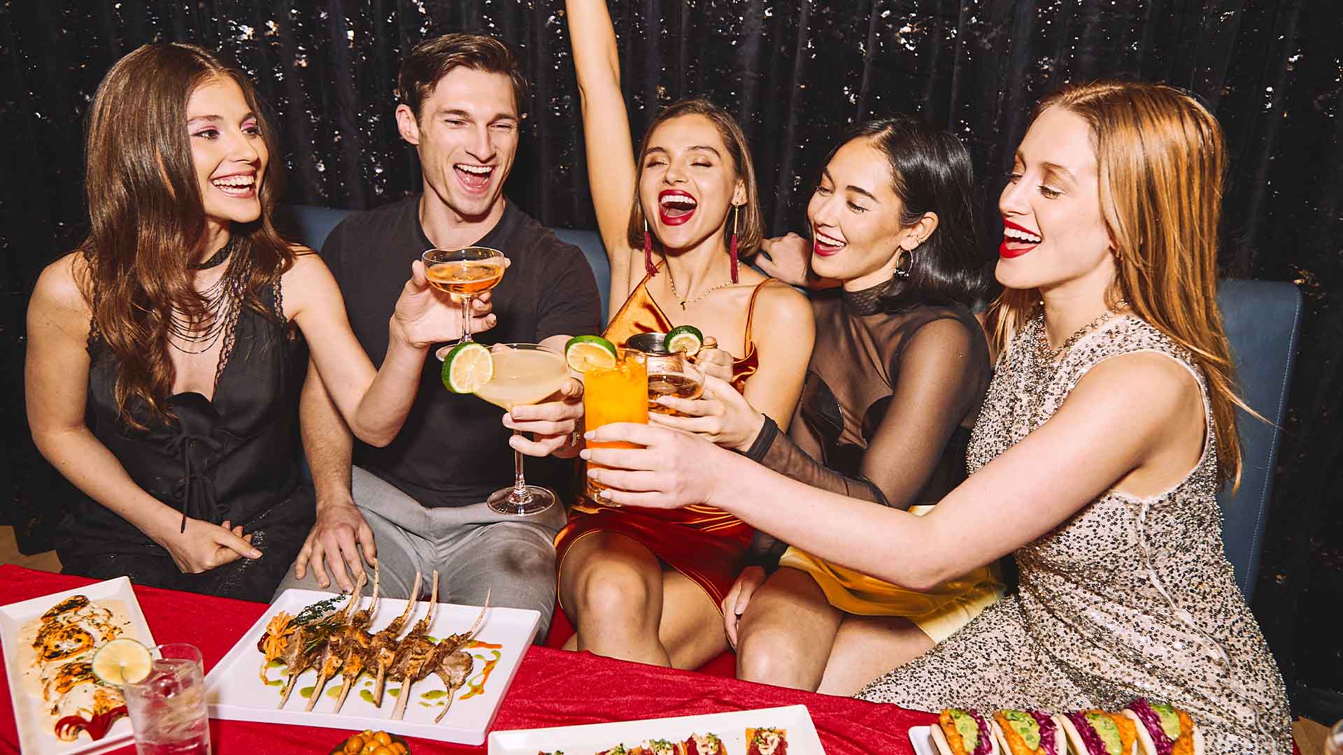 Group of adults celebrating with food and drinks