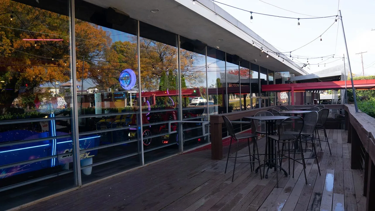 Spacious patio with seating and lights.