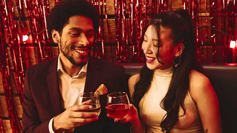 Coworkers toasting drinks at Lucky Strike event.