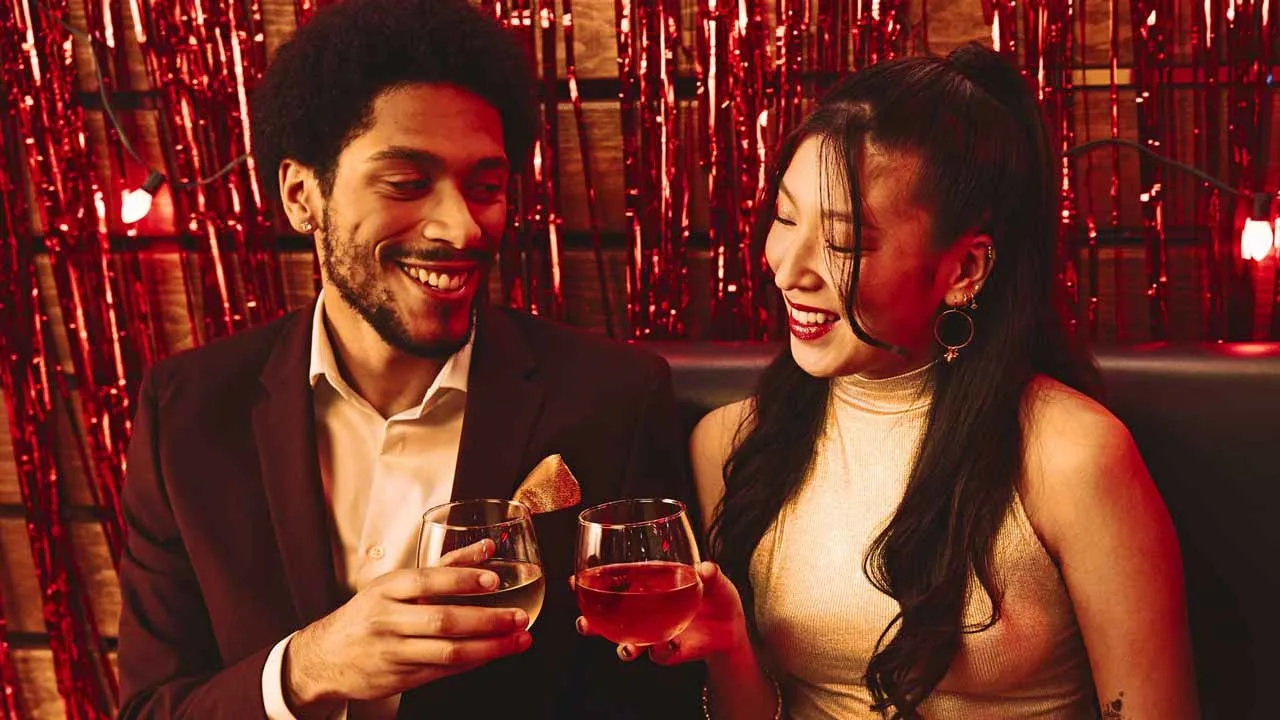 Coworkers toasting drinks at Lucky Strike event.