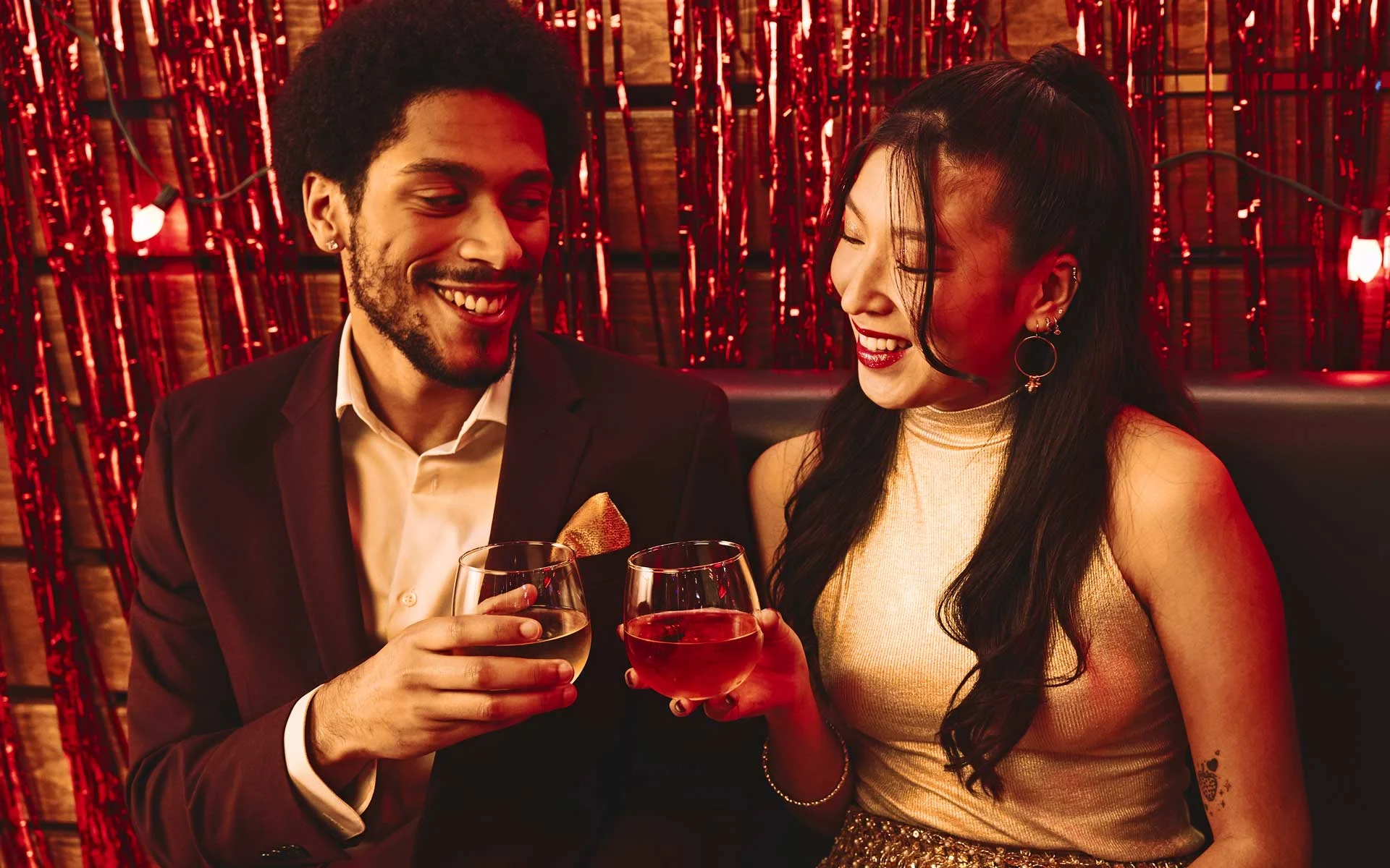 Coworkers toasting drinks at Lucky Strike event.