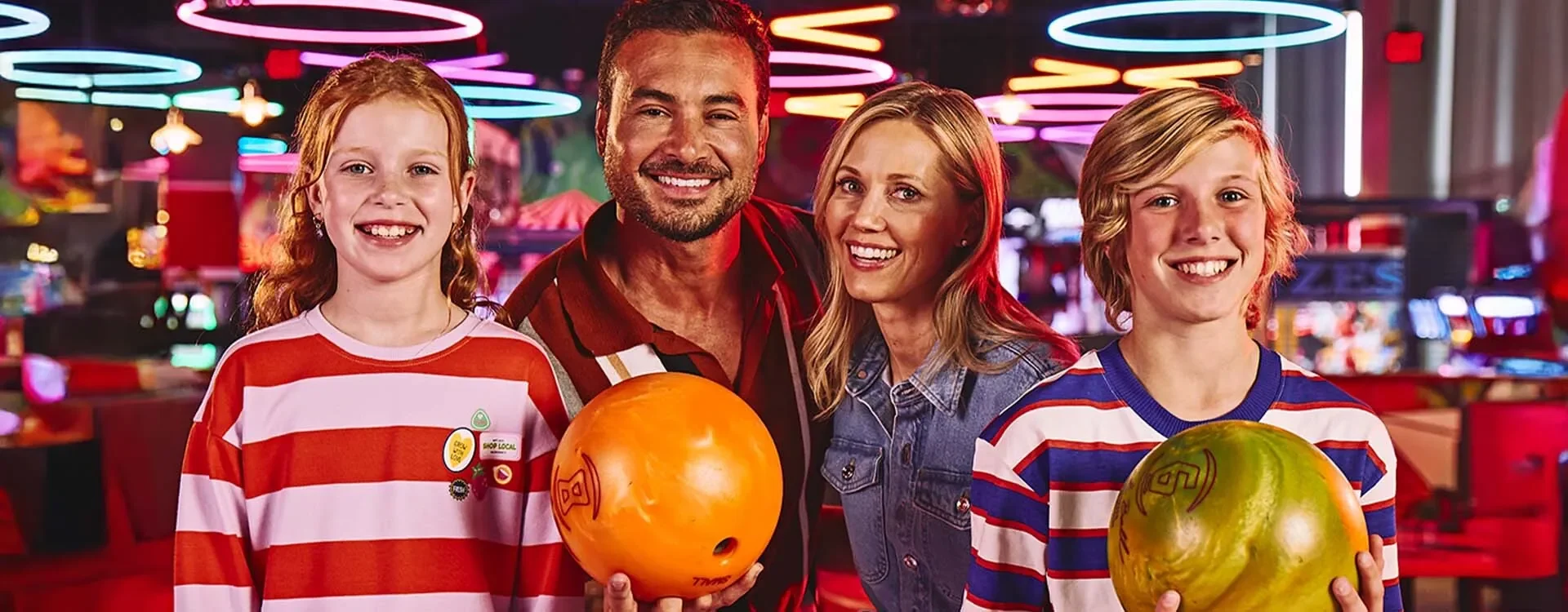 Family with bowling alley in the background