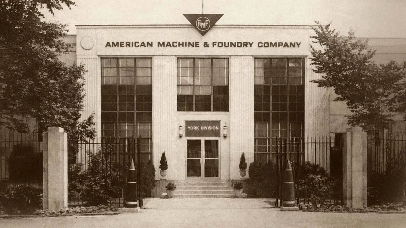 Vintage sepia-toned image of the American Machine & Foundry Company York Division office building with the AMF logo and company name displayed above the entrance.