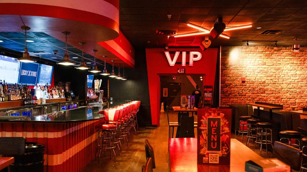 Beautiful bar with lots of seating and large TV screens above the bar and a VIP entrance