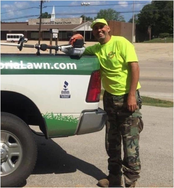 Dave Bachman of Peoria Lawn standing next to work truck