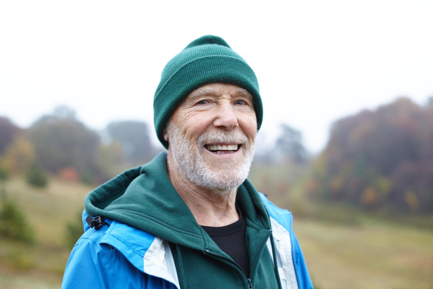 Older man wearing a beanie smiling