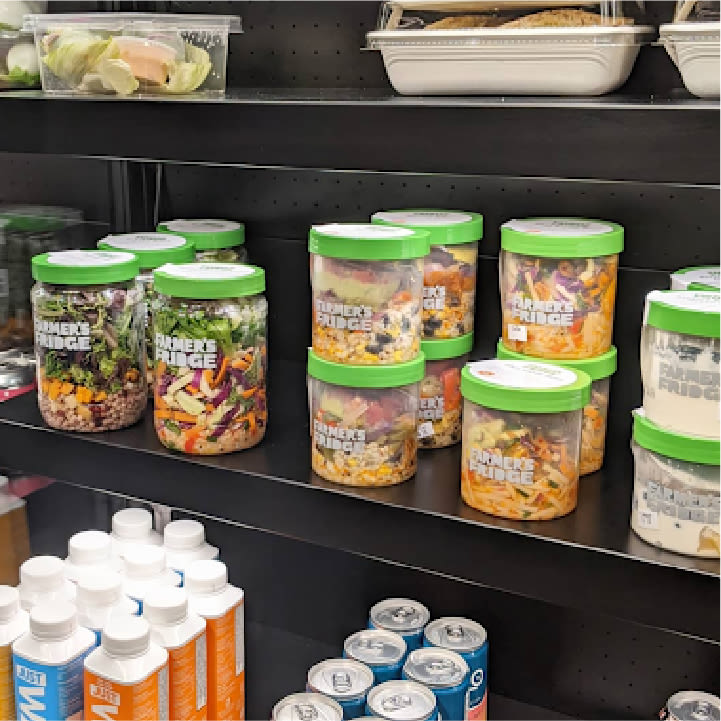 Farmer's Fridge jars displayed in a retail cooler